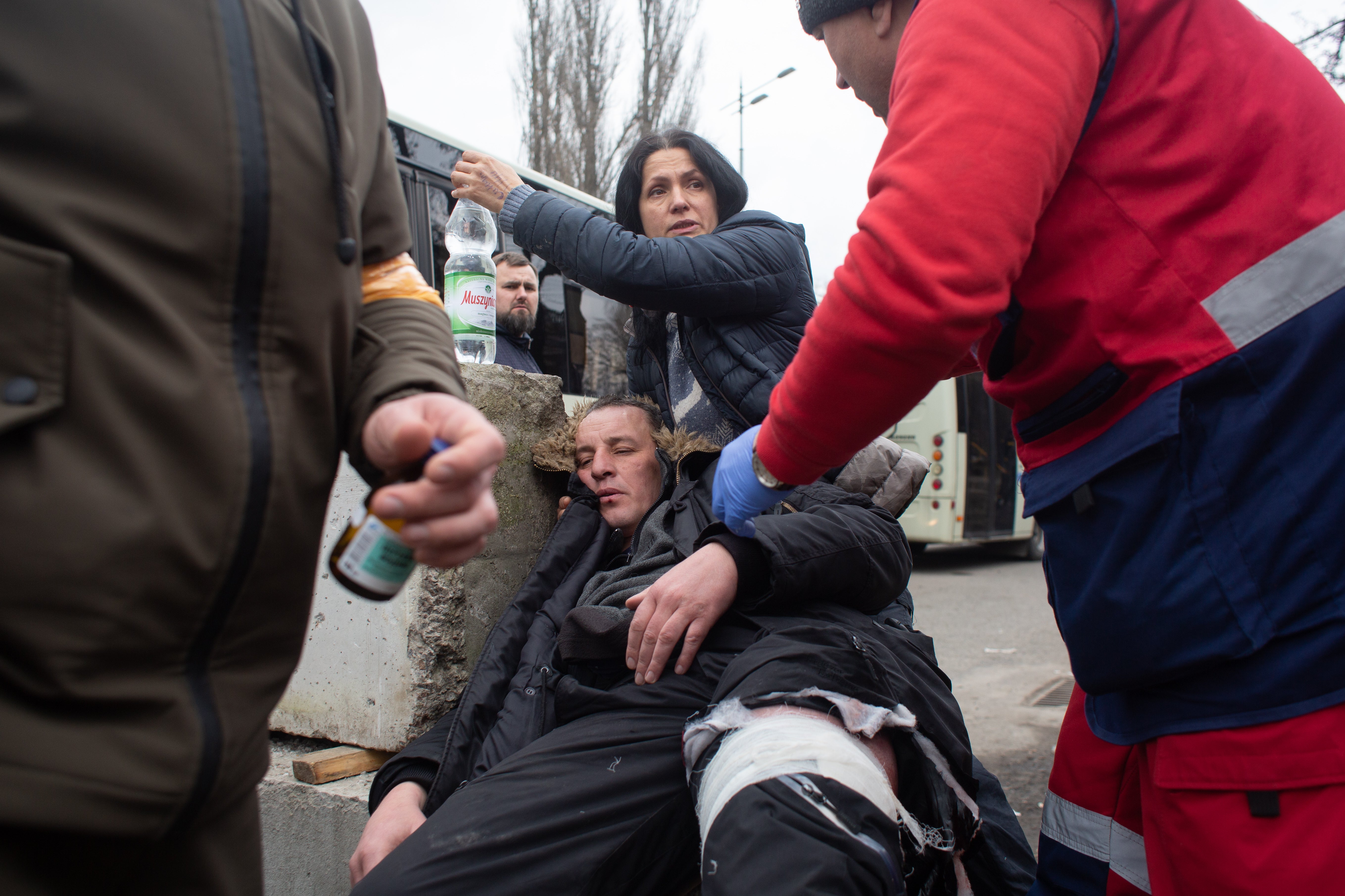 Yuriy, who who was shot in the leg while evacuating civilians from the shelled city of Irpin receives first aid on 6 March 2022