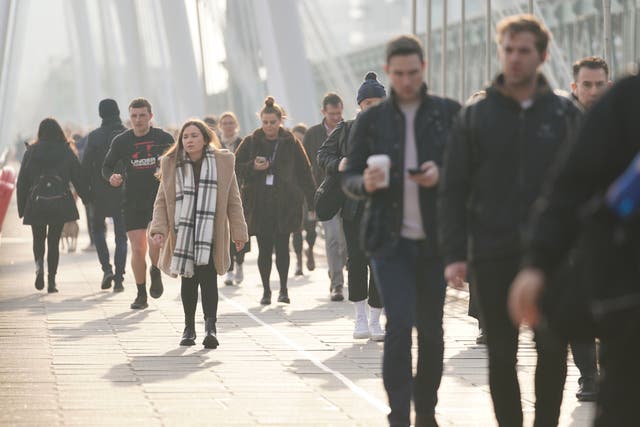 Commuters crossing the Golden Jubilee Bridge in London (Kirsty O’Connor/PA)