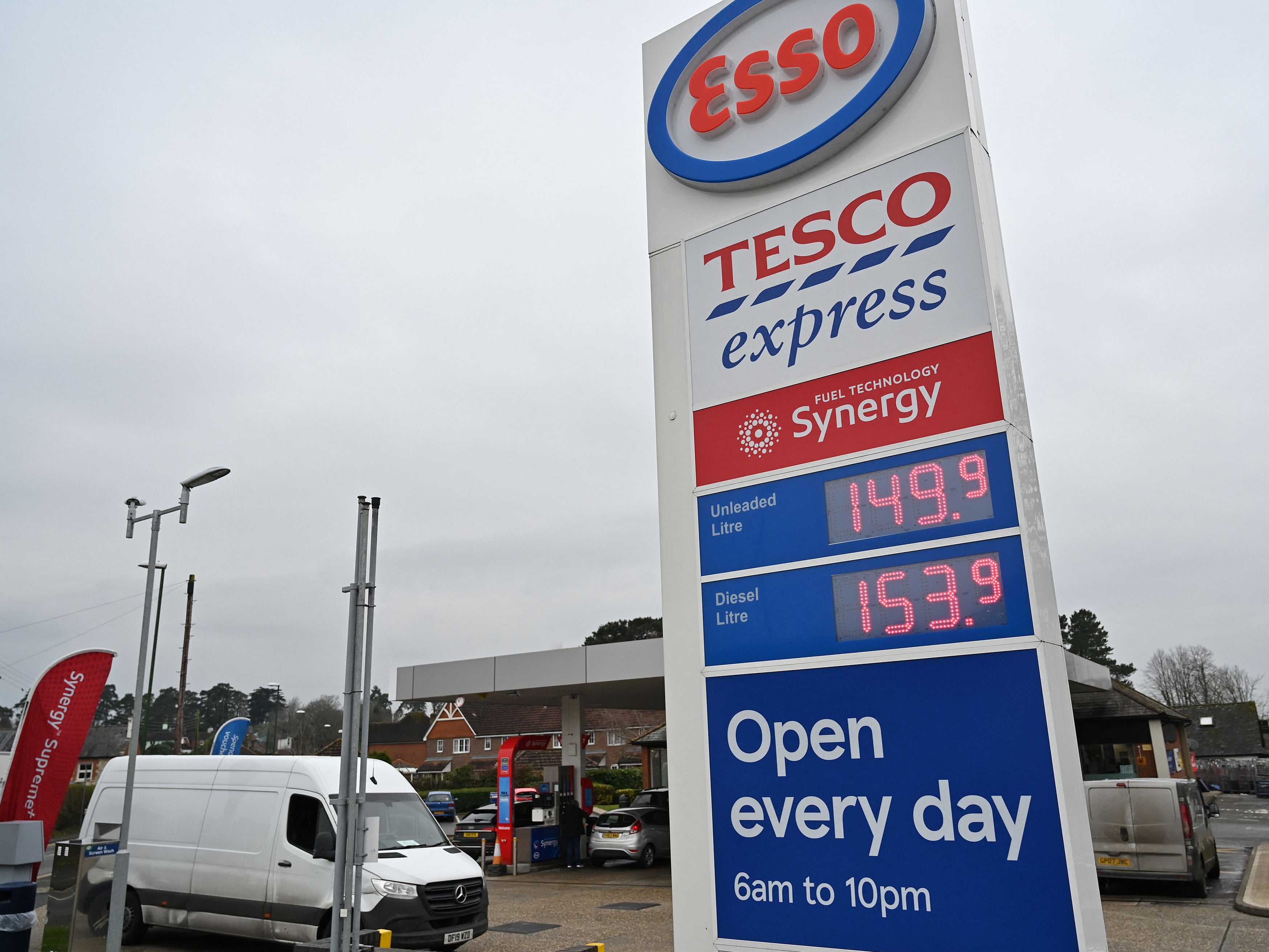 The price of petrol and diesel fuels are displayed on a board outside an Esso petrol station in Storrington, southern England