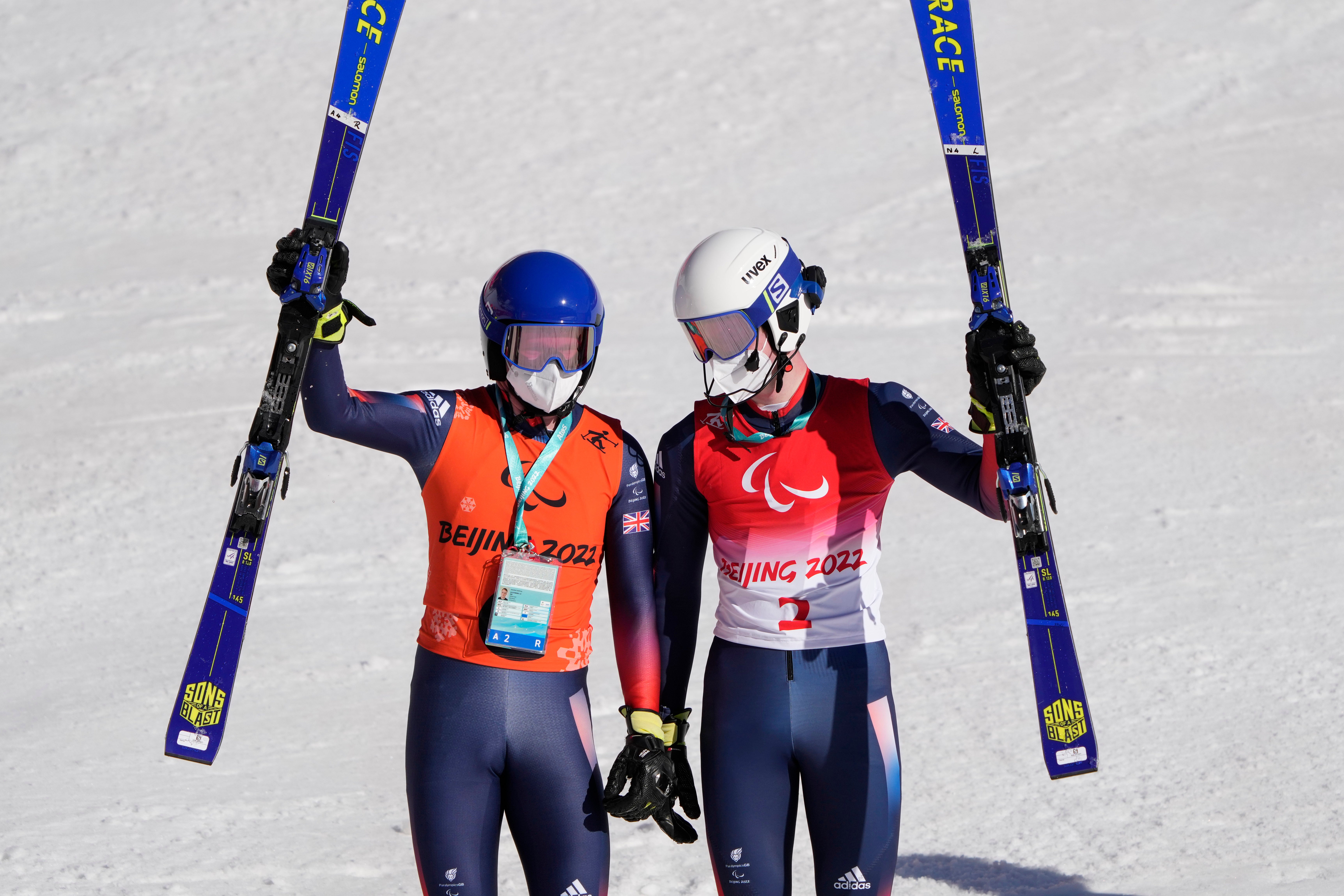 Neil Simpson, right, and guide and brother Andrew celebrate their bronze medal in the Super Combined (Andy Wong/AP)