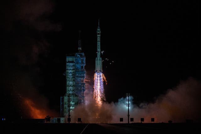 <p>The Shenzhou-13 carried by a Long March-2F rocket launches with three astronauts from China Manned Space Agency on board early on October 16, 2021</p>