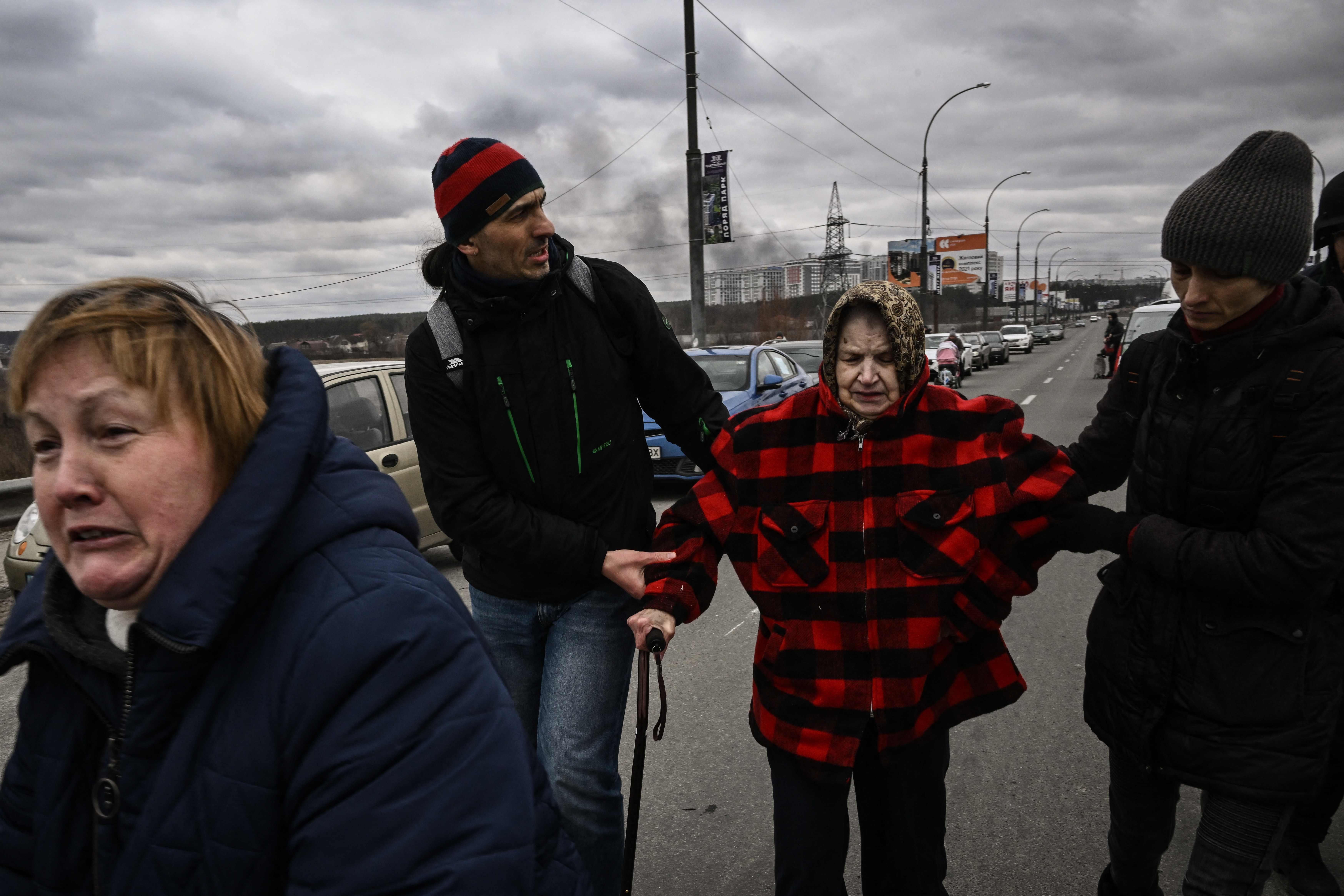 Ukrainians evacuate Irpin, a city near Kyiv.