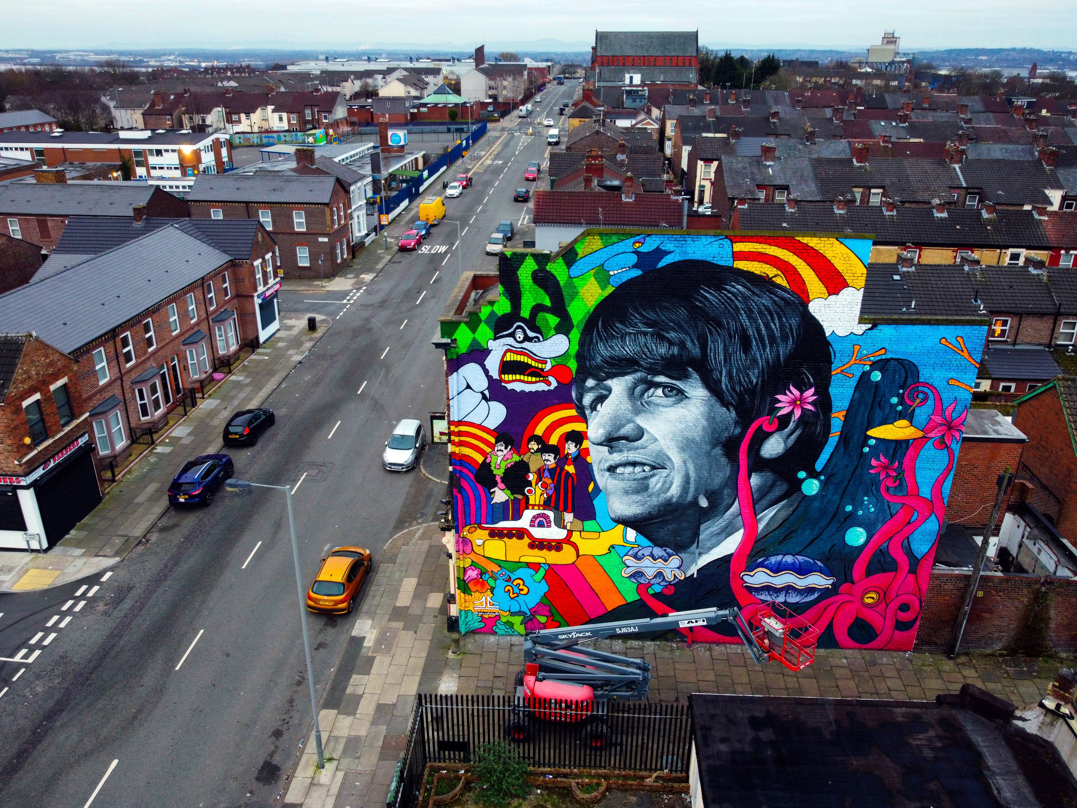 A mural of Ringo Starr, by Liverpool artist John Culshaw, is unveiled on the gable end of The Empress pub in Admiral Street in Toxteth, across the road from the former Beatle’s childhood home (Peter Byrne/PA)