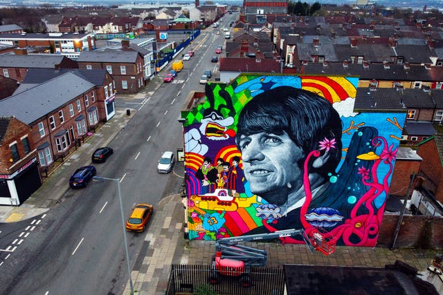 A mural of Ringo Starr, by Liverpool artist John Culshaw, is unveiled on the gable end of The Empress pub in Admiral Street in Toxteth, across the road from the former Beatle’s childhood home (Peter Byrne/PA)