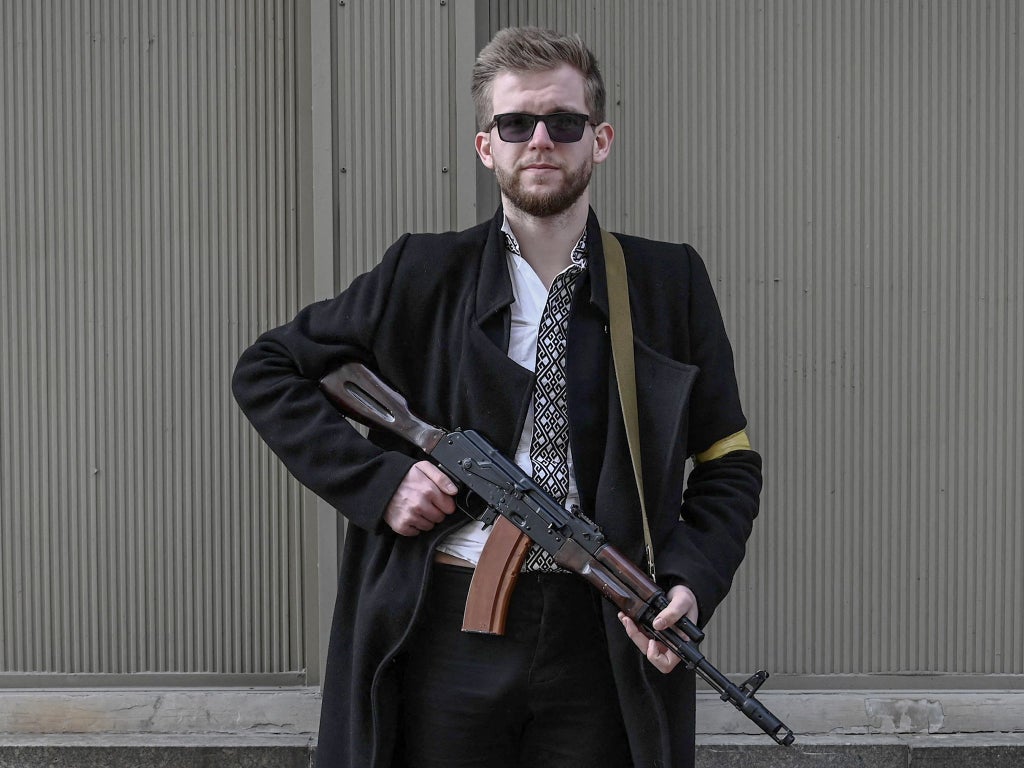 Ukraine’s youngest MP helps defend Kyiv with an AK-47 strapped to his back: ‘We either fight and survive – or we fall’