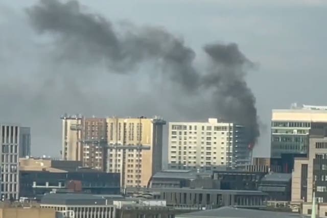 <p>Smoke rises from building on fire in east London </p>