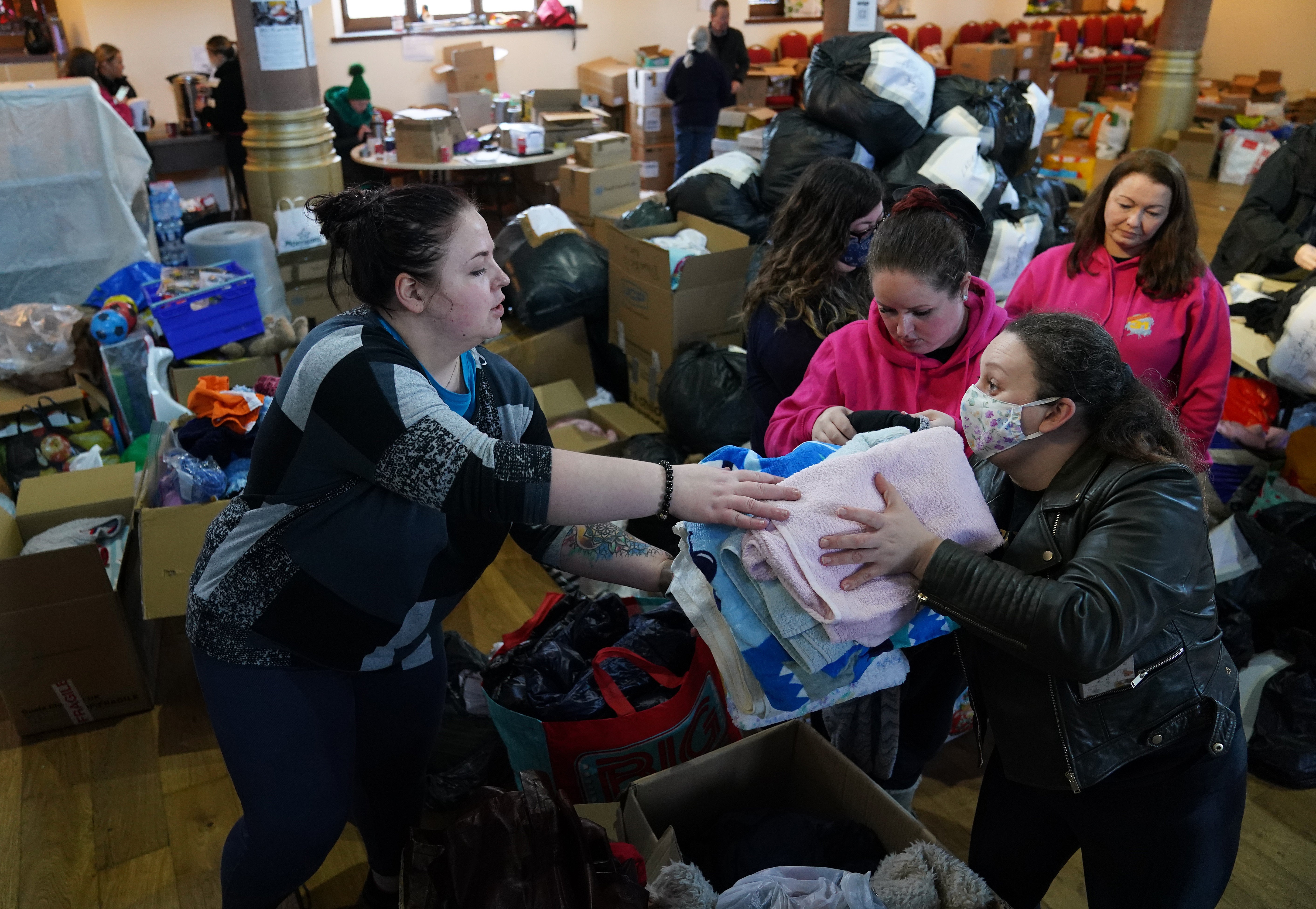 Volunteers from Rain or Shine, South Lanarkshire check through donations bound for Ukraine at Old Trinity Church in Cambuslang. Picture date: Monday March 7, 2022.