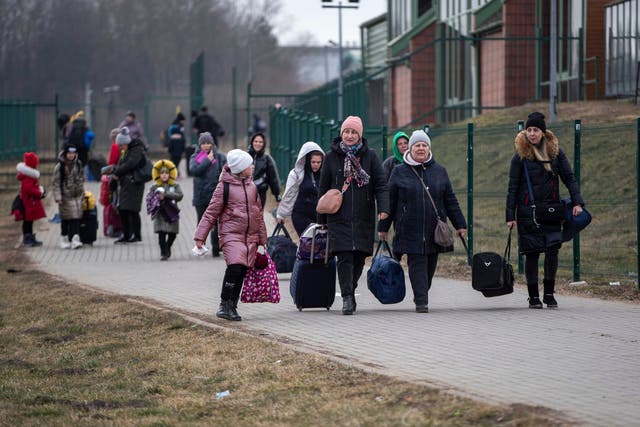 Women and children fleeing from Ukraine arrive at the border crossing in Medyka, Poland (Visar Kryeziu/AP)