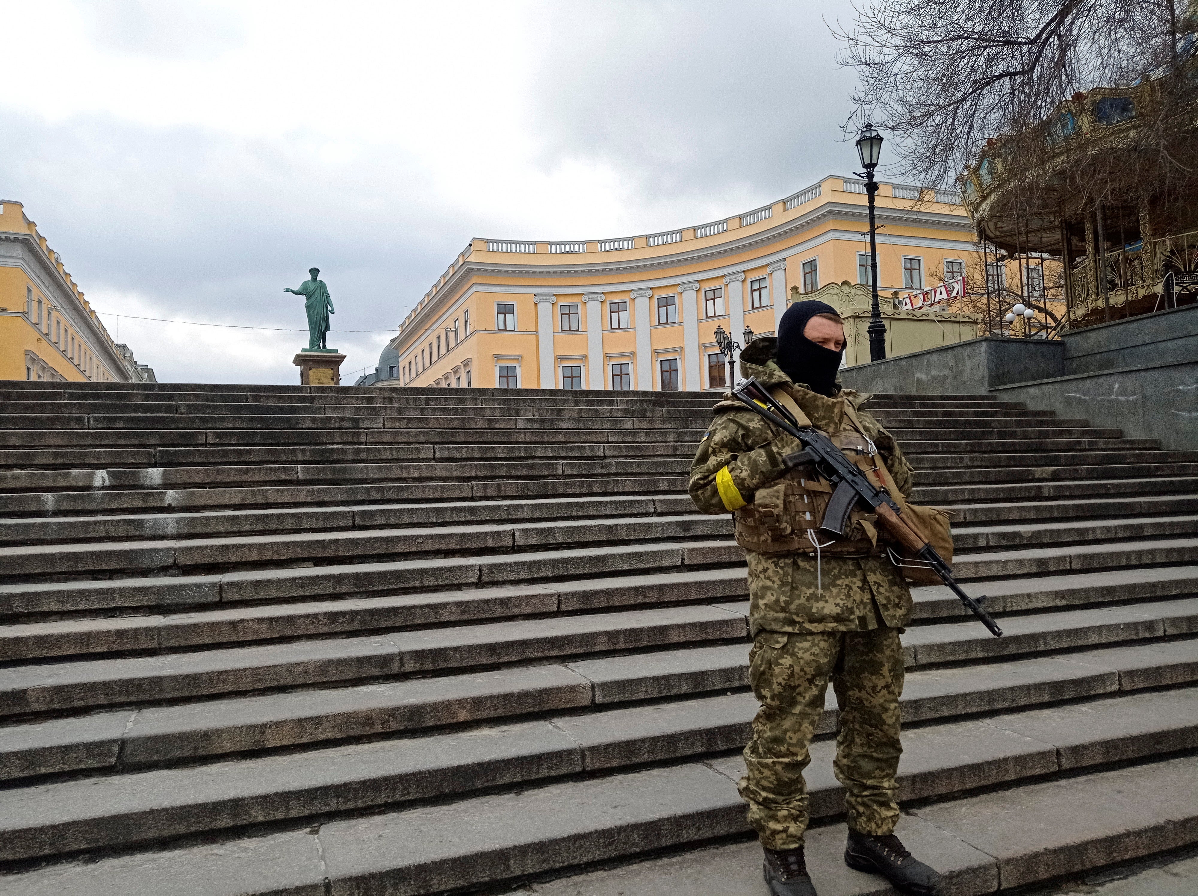 A member of the Ukrainian Territorial Defence Forces stands guard in central Odesa