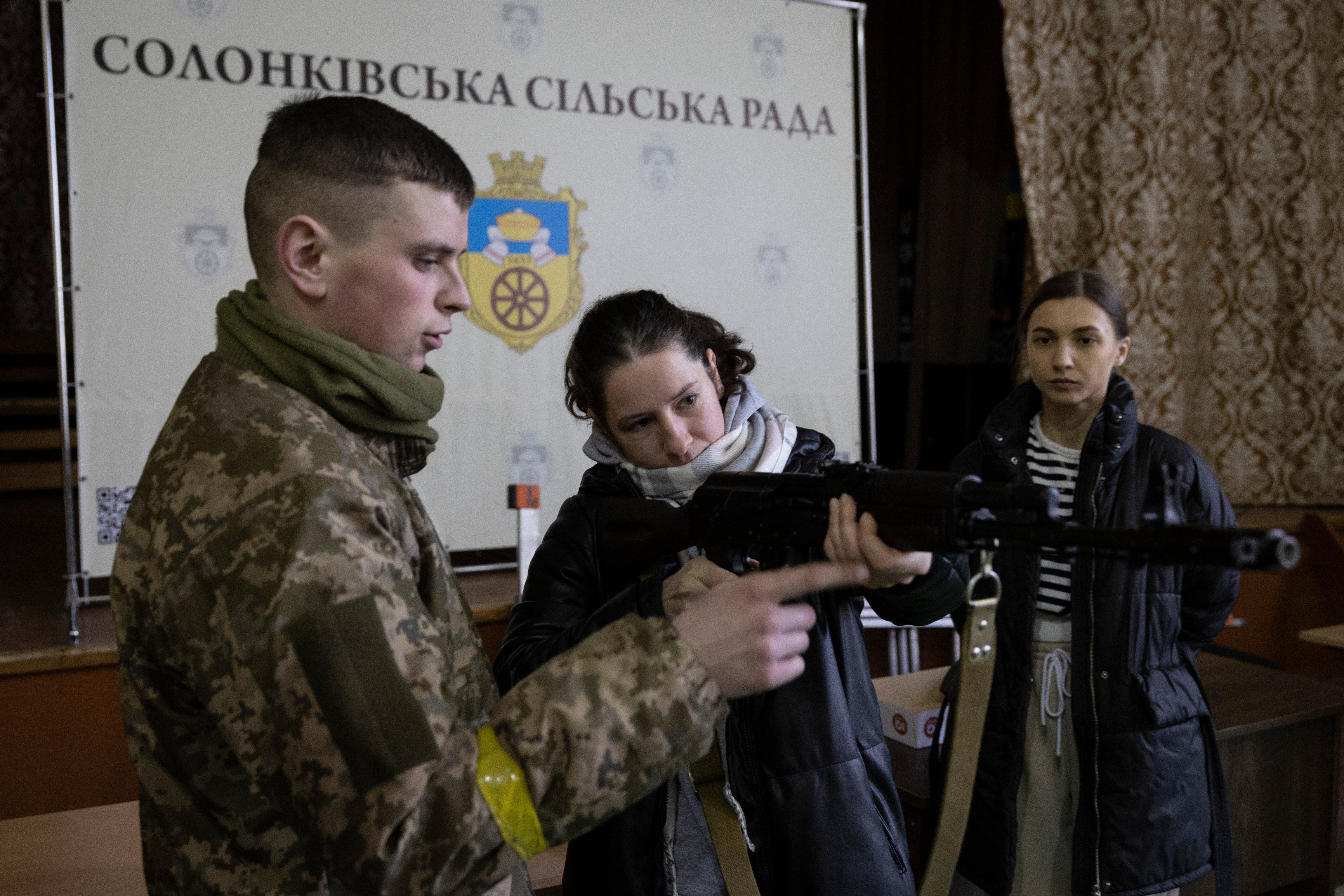 Members of the public are given weapons training at the Solonka administration building in Lviv, Ukraine