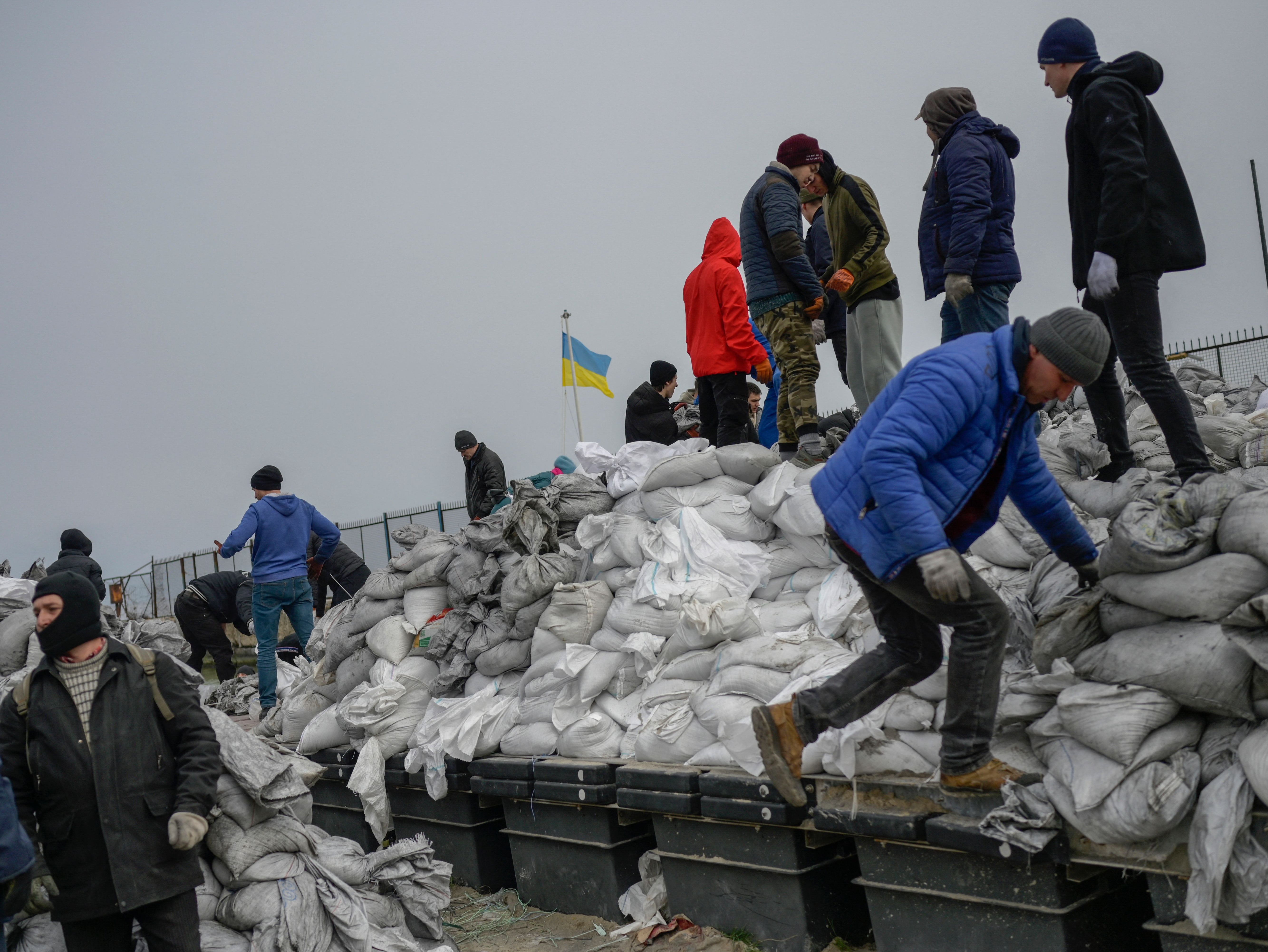 Local residents of the city fill bags with sand to prepare their frontlines against Russian forces