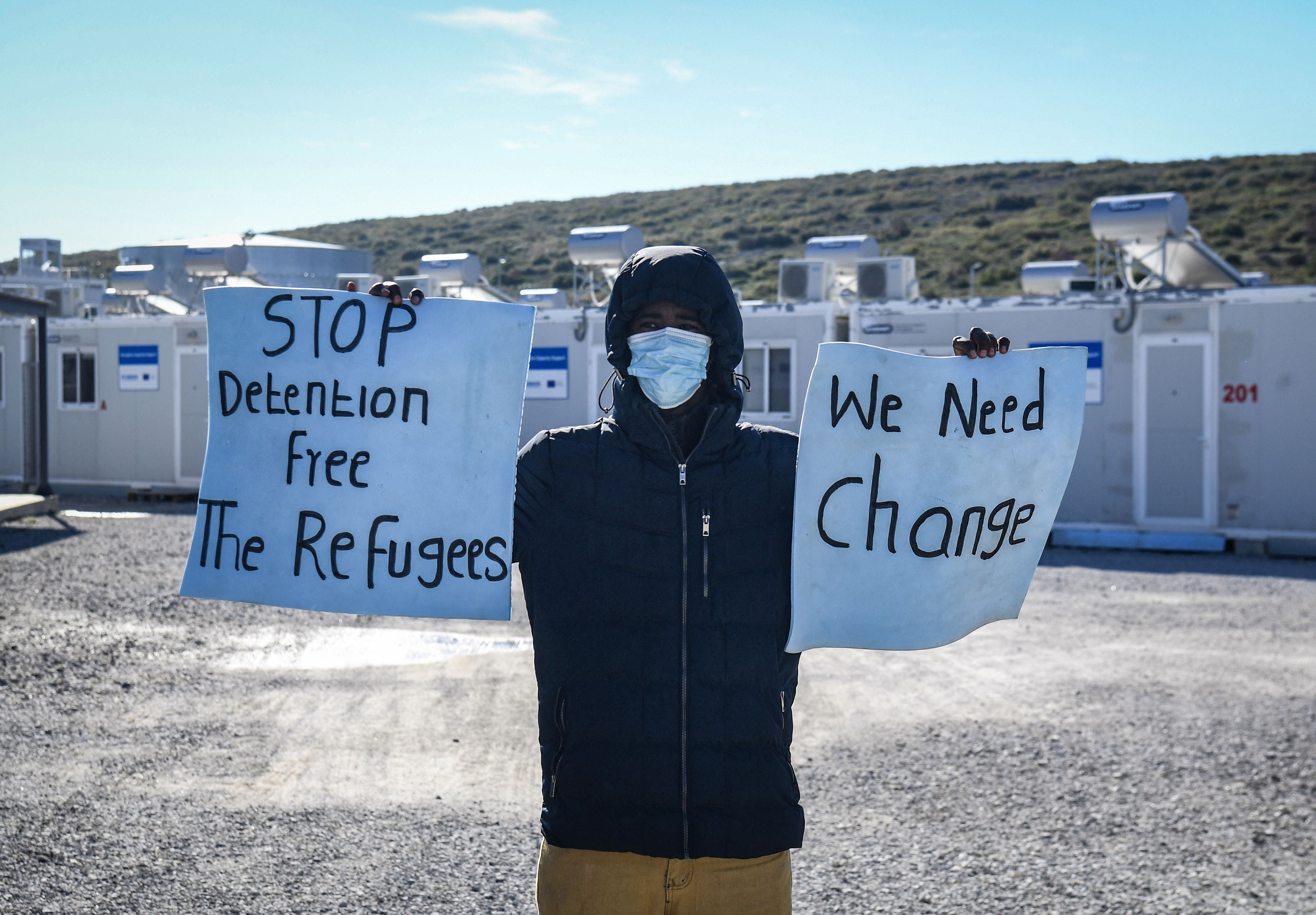 File photo: A Somali refugee holds placards in the camp for migrants in Zervos on Samos, Greece, 15 January 2022