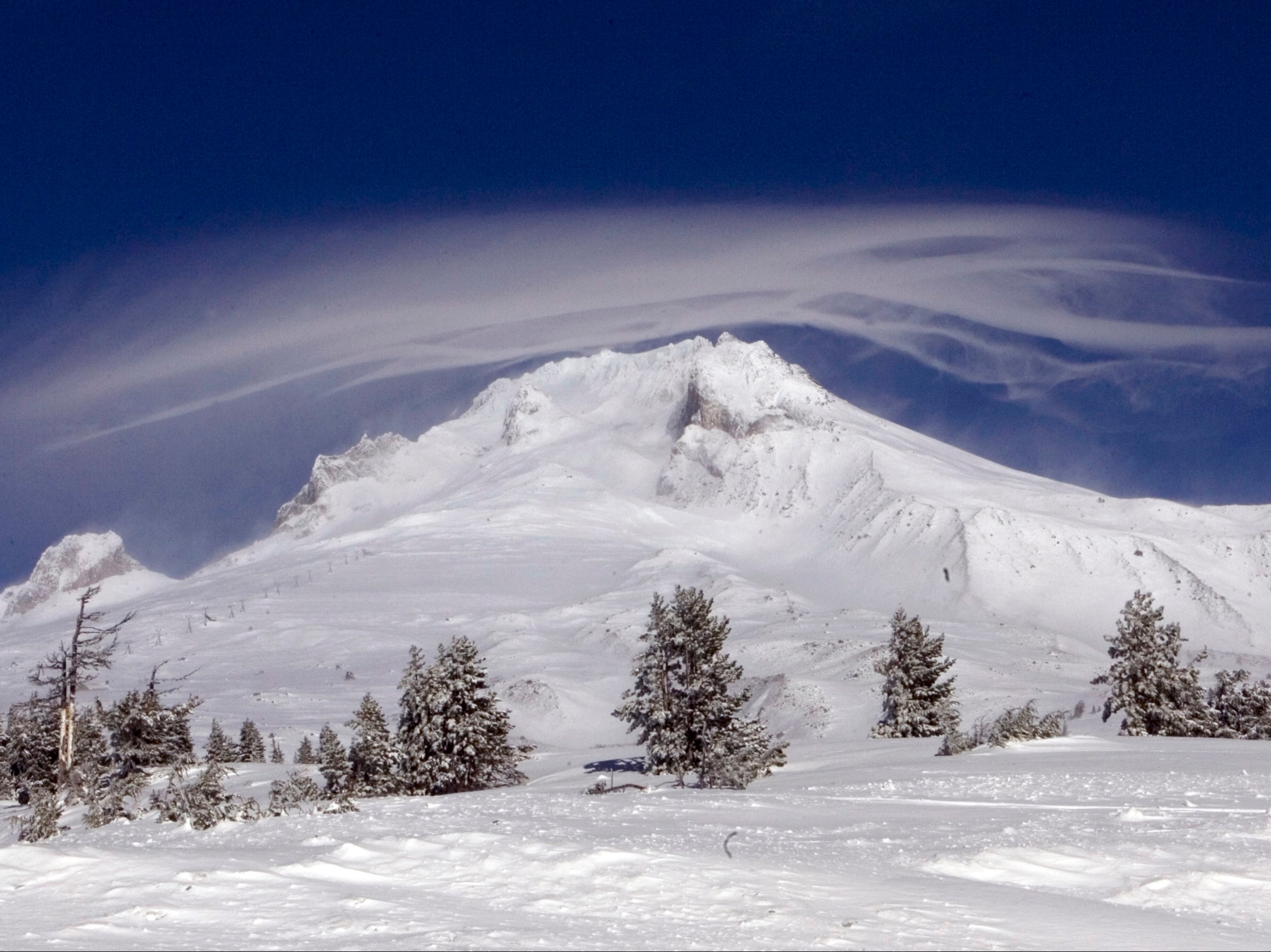 A cloud forms over Mount Hood where two of three climbers are still missing at Government Camp, Ore., Sunday, Dec. 13, 2009. Weather conditions hampered the rescue efforts. The body of one climber was removed from the mountain Saturday.(AP Photo/Don Ryan)