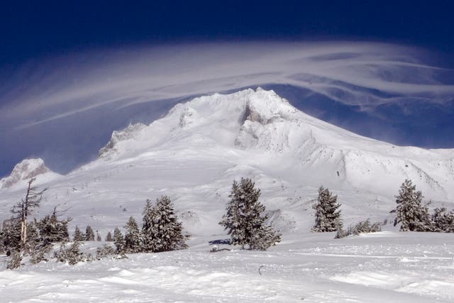 <p>A cloud forms over Mount Hood where two of three climbers are still missing at Government Camp, Ore., Sunday, Dec. 13, 2009.  Weather conditions hampered the rescue efforts. The body of one climber was removed from the mountain Saturday.(AP Photo/Don Ryan)</p>