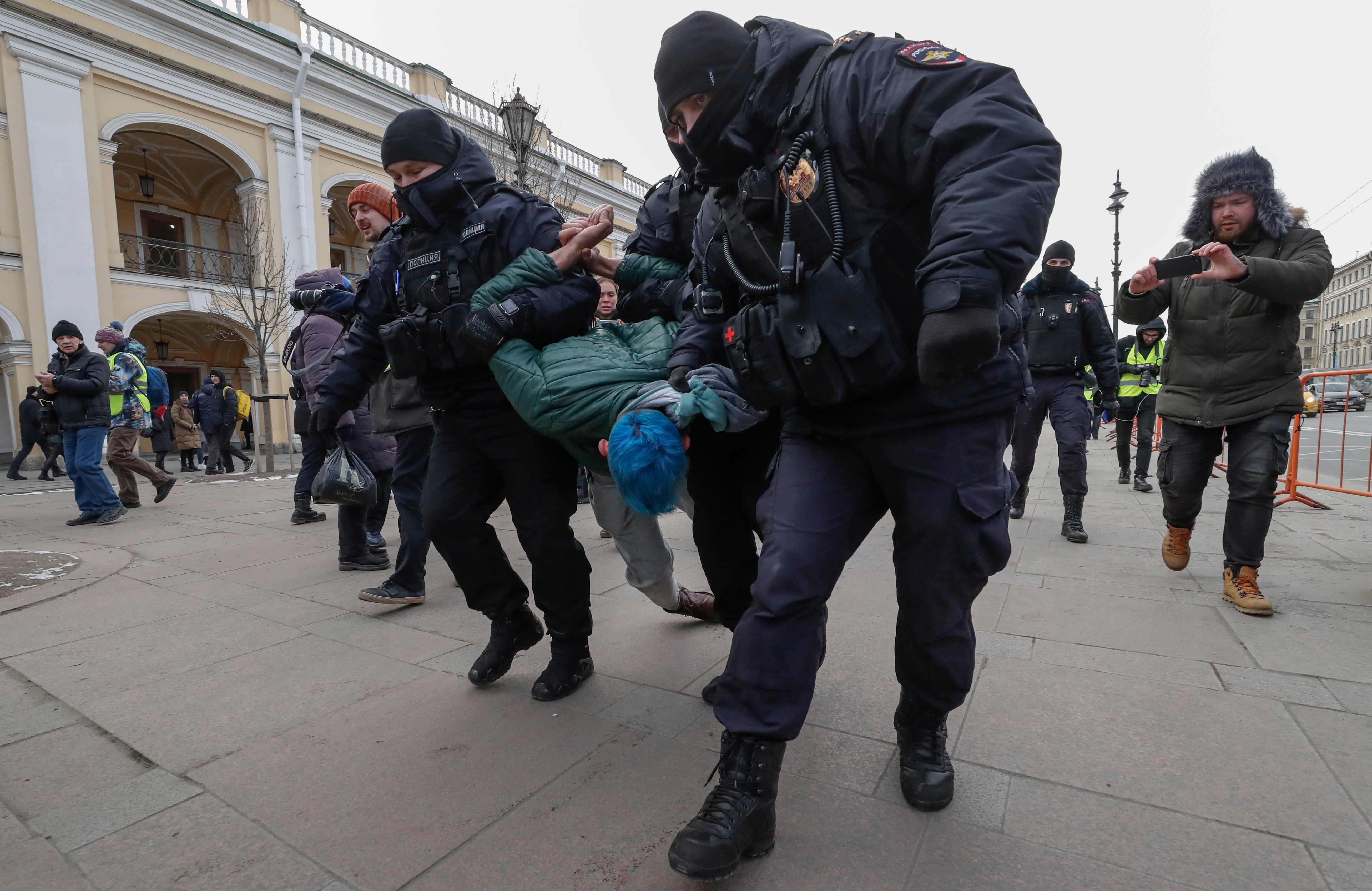 An anti-war demonstrator is detained in St Petersburg, Russia, on 8 March