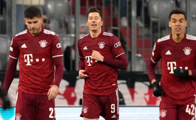 Robert Lewandowski (centre) celebrates after completing his hat-trick in the 7-1 victory over RB Salzburg (Matthias Schrader/AP)