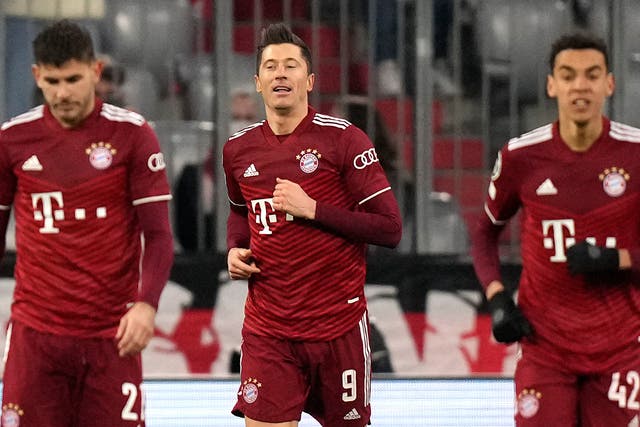 Robert Lewandowski (centre) celebrates after completing his hat-trick in the 7-1 victory over RB Salzburg (Matthias Schrader/AP)
