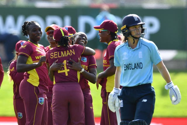<p>West Indies players celebrate the dismissal of England's Amy Jones</p>