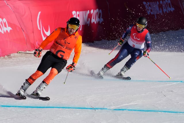 <p>Brett Wild guides Millie Knight during the super-G event</p>