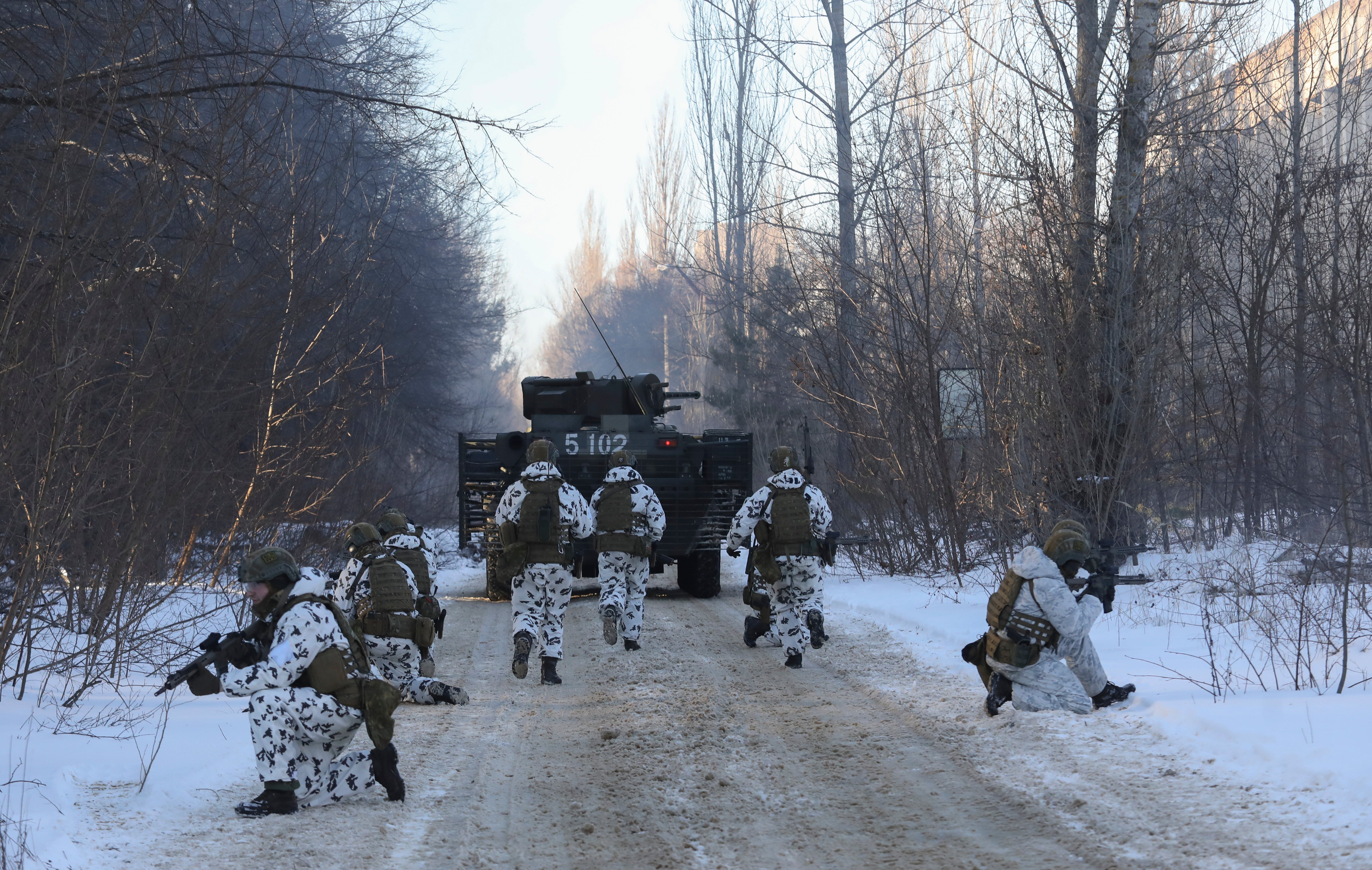 Ukrainian armed forces simulate a crisis situation in an urban settlement in the abandoned city of Pripyat near the Chernobyl plant in the weeks before the Russian invasion