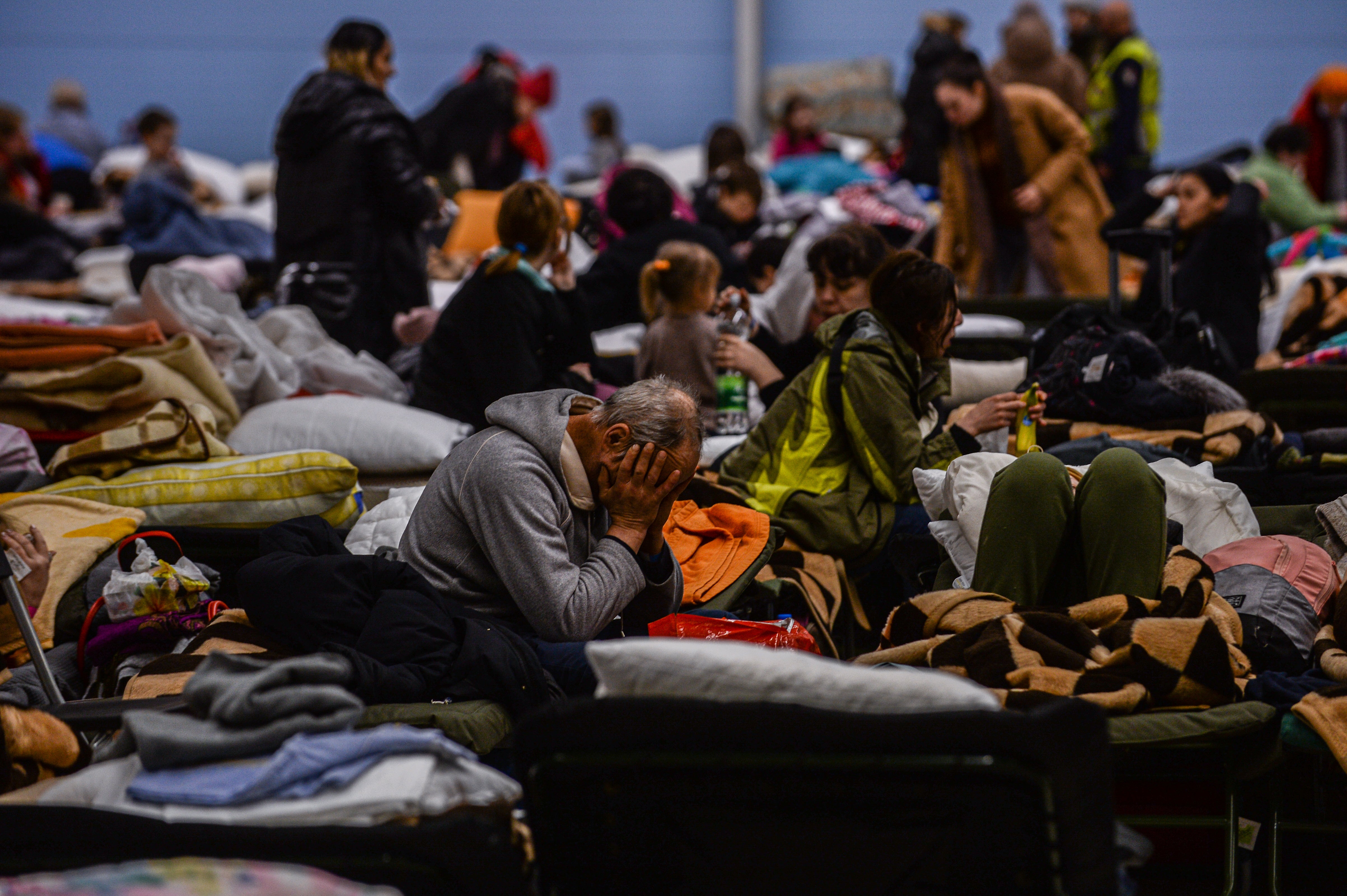 Refugees inside a temporary shelter that was an abandoned Tesco supermarket in Przemysl, Poland