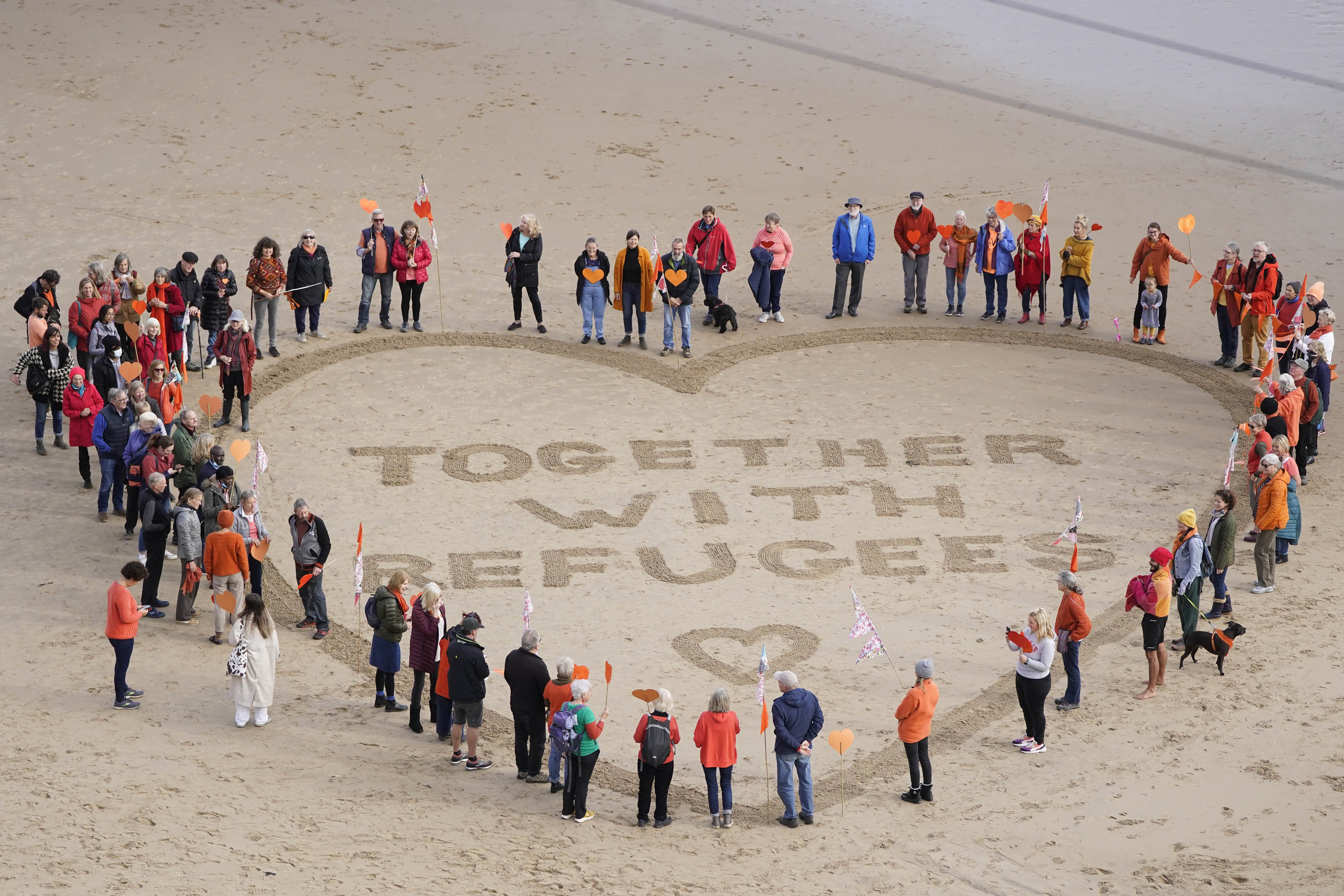 Demonstrators on King Edward’s Bay Beach in Tynemouth show solidarity for refugees with a protest against the Nationality and Borders Bill