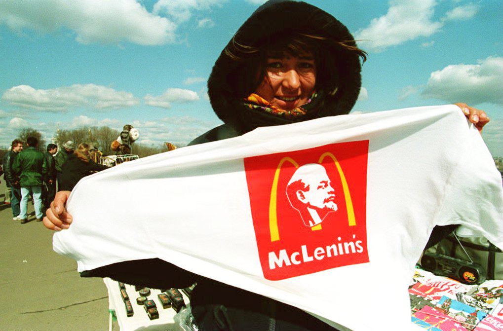 Woman displays a t-shirt for sale in Moscow, in 1994