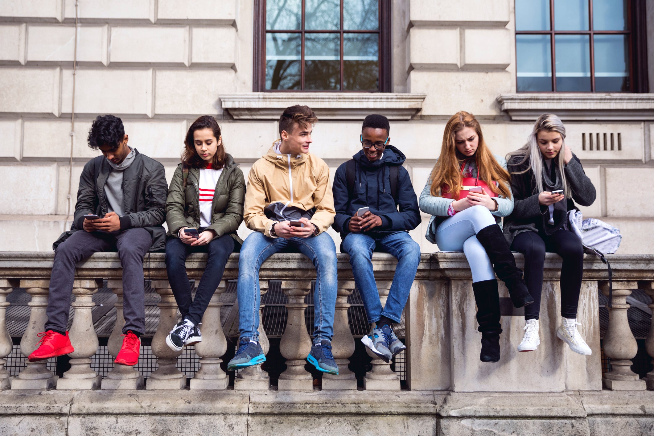 Teenagers sitting on a wall