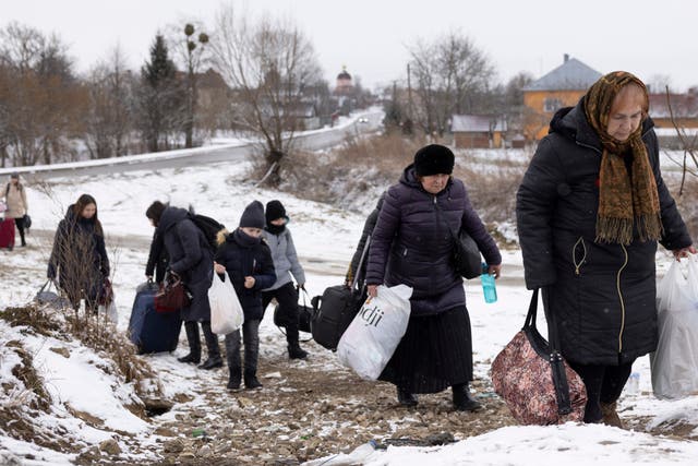 <p>Refugees make their way to the Krakovets border crossing with Poland </p>