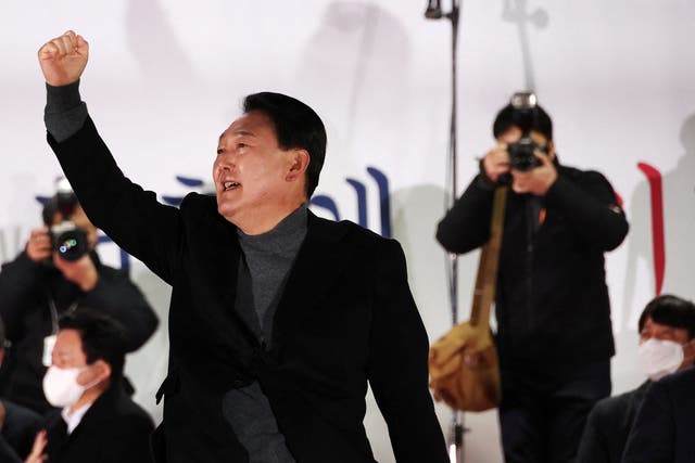 <p>File: Yoon Suk-yeol, the new president of South Korea from the main opposition People Power Party (PPP), gestures during an election campaign rally in Seoul</p>