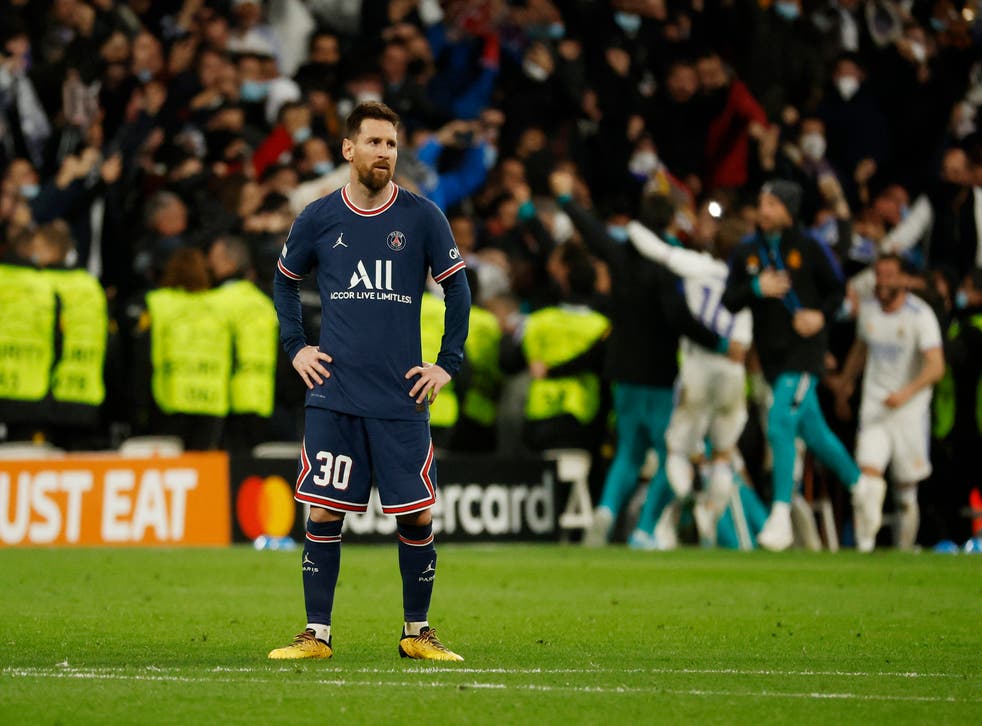 <p>Lionel Messi looks on as Real Madrid celebrate</p>