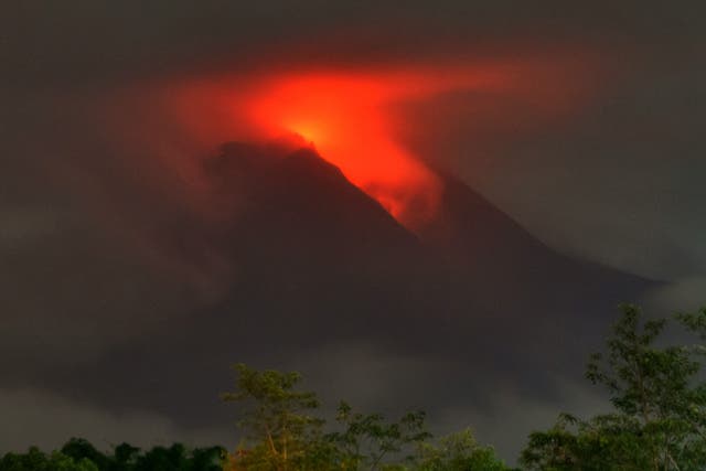 <p>Lava flows down from the crater of Indonesia's most active volcano Mount Merapi, seen from the village of Plunyon in Sleman</p>