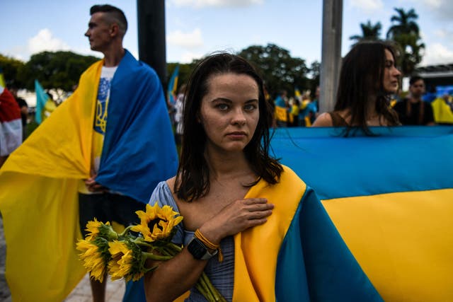 <p>A woman wears sunflowers in support of Ukraine at an anti-war demonstration in Miami, Florida</p>