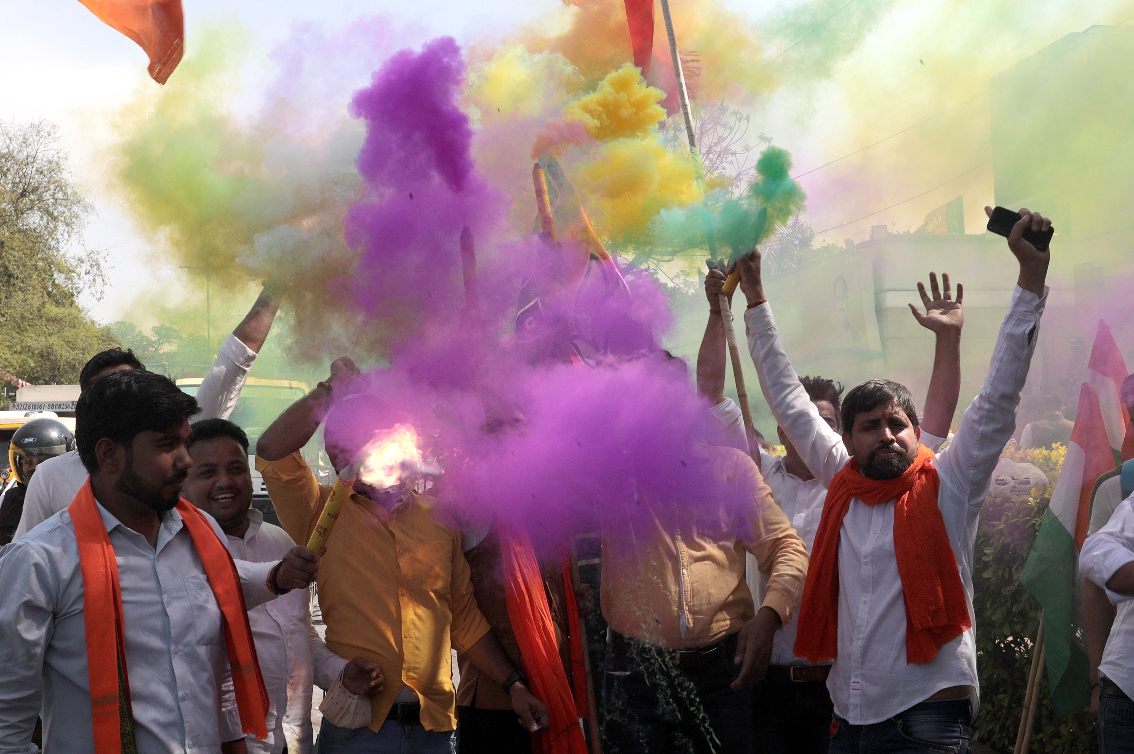 BJP workers and supporters celebrate outside their party office in New Delhi on 10 March