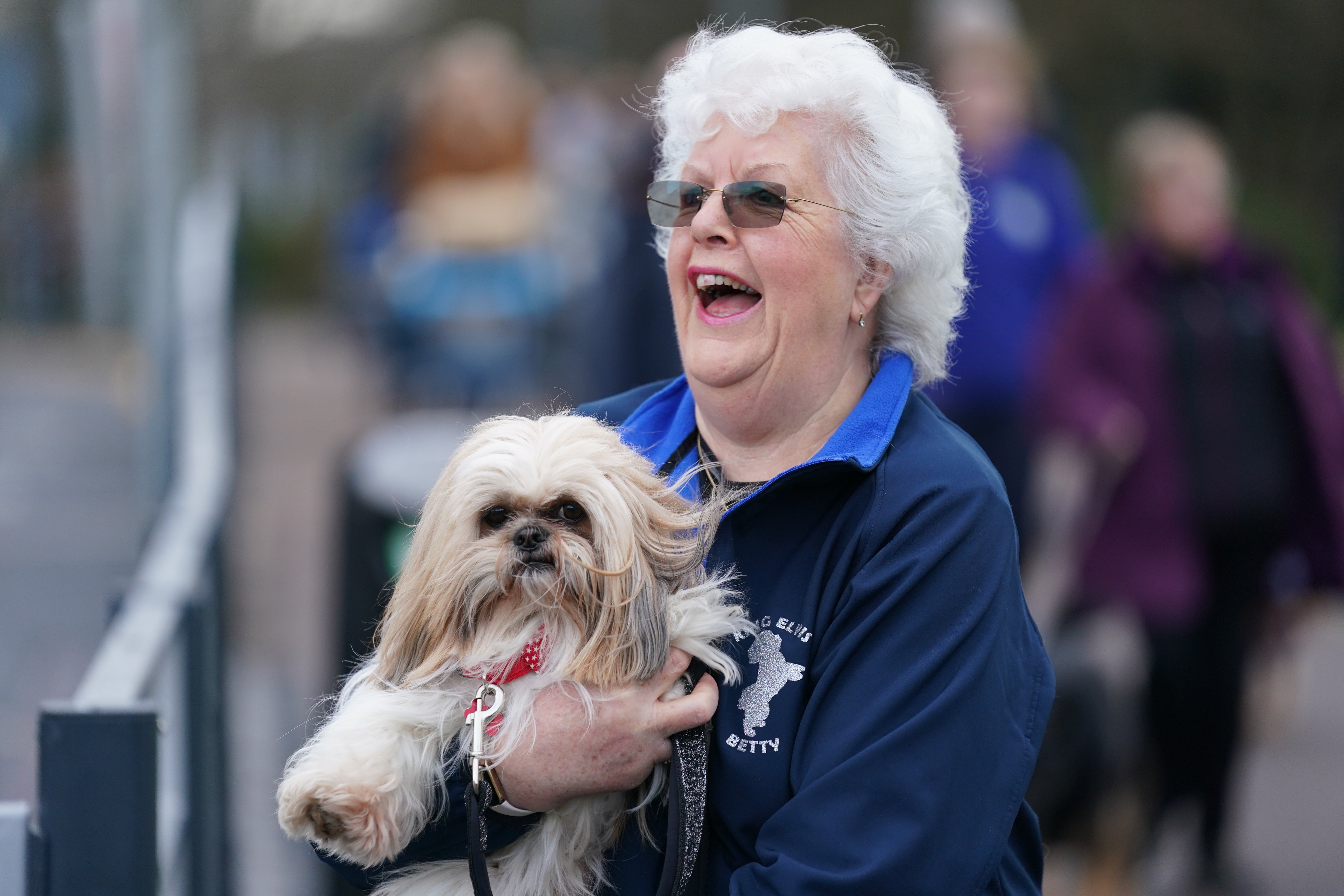 A woman holds a Shih Tzu, on the first day of Crufts (Jacob King/PA)