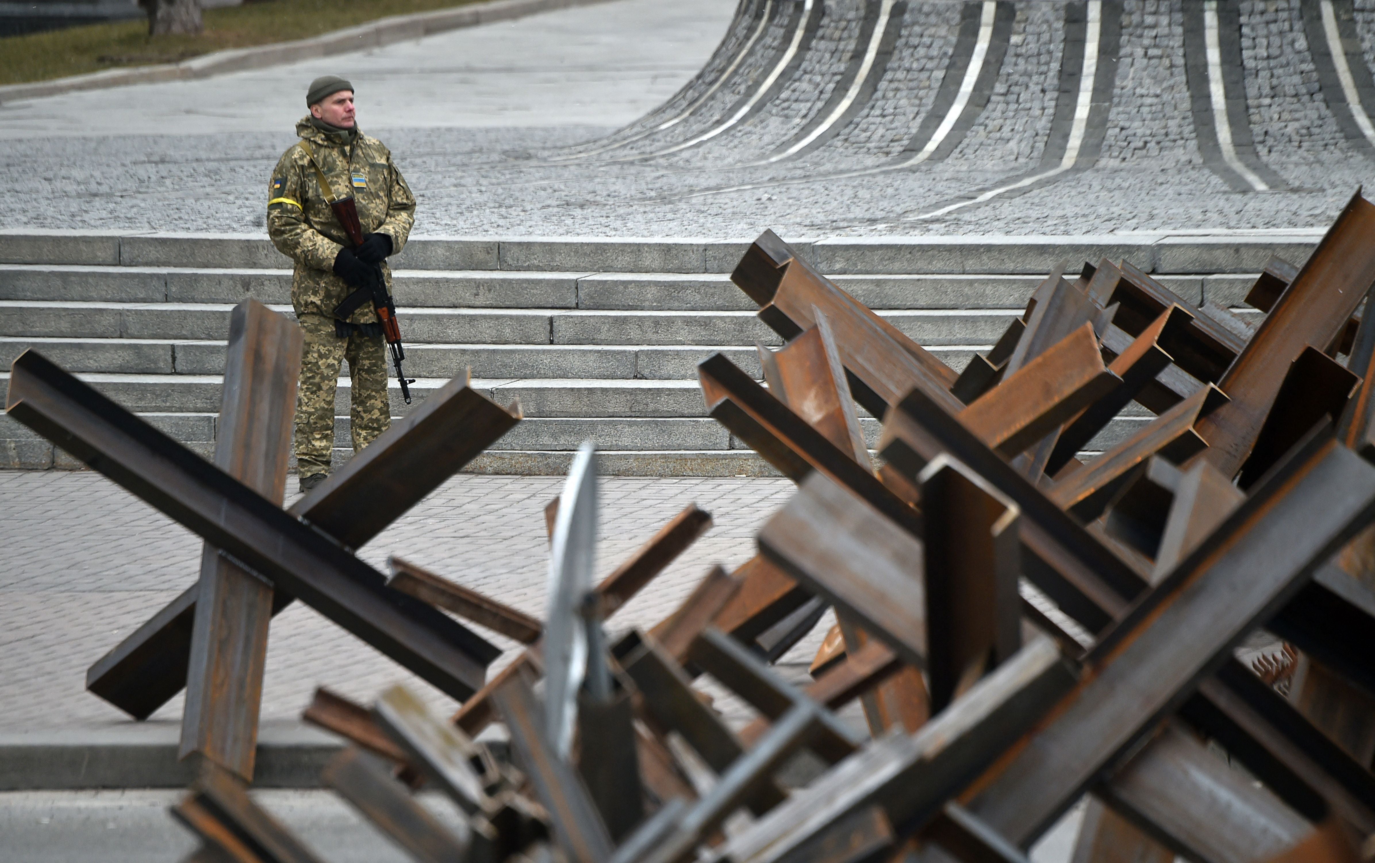 File photo: A member of the Ukrainian territorial defence forces stands guard next to anti-tank structures blocking the streets of the centre of Kyiv, 6 March 2022