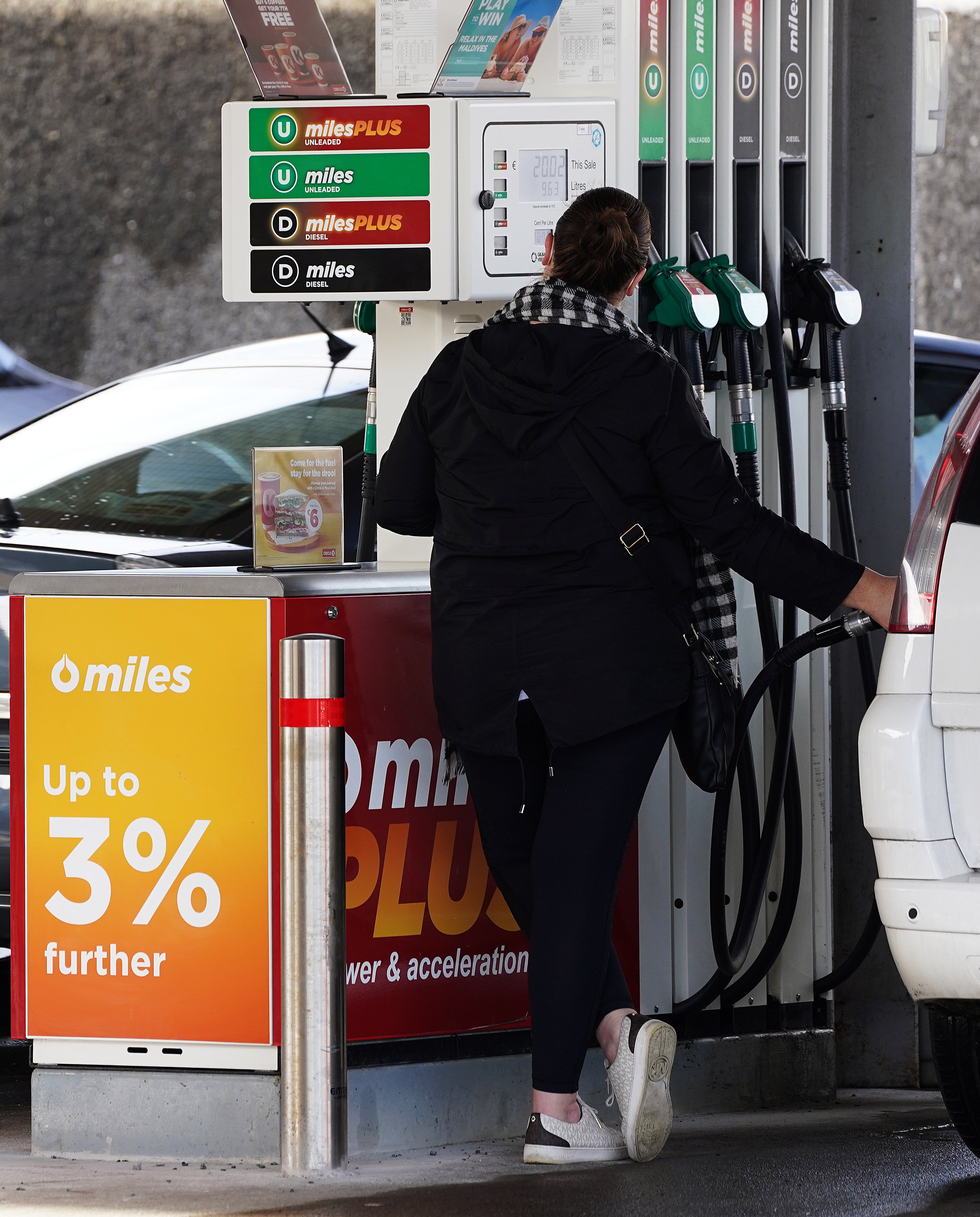 A woman at a fuel pump in a Circle K service station on Glasnevin Avenue in Dublin, following a significant cut in the excise duty on fuel (Brian Lawless/PA)