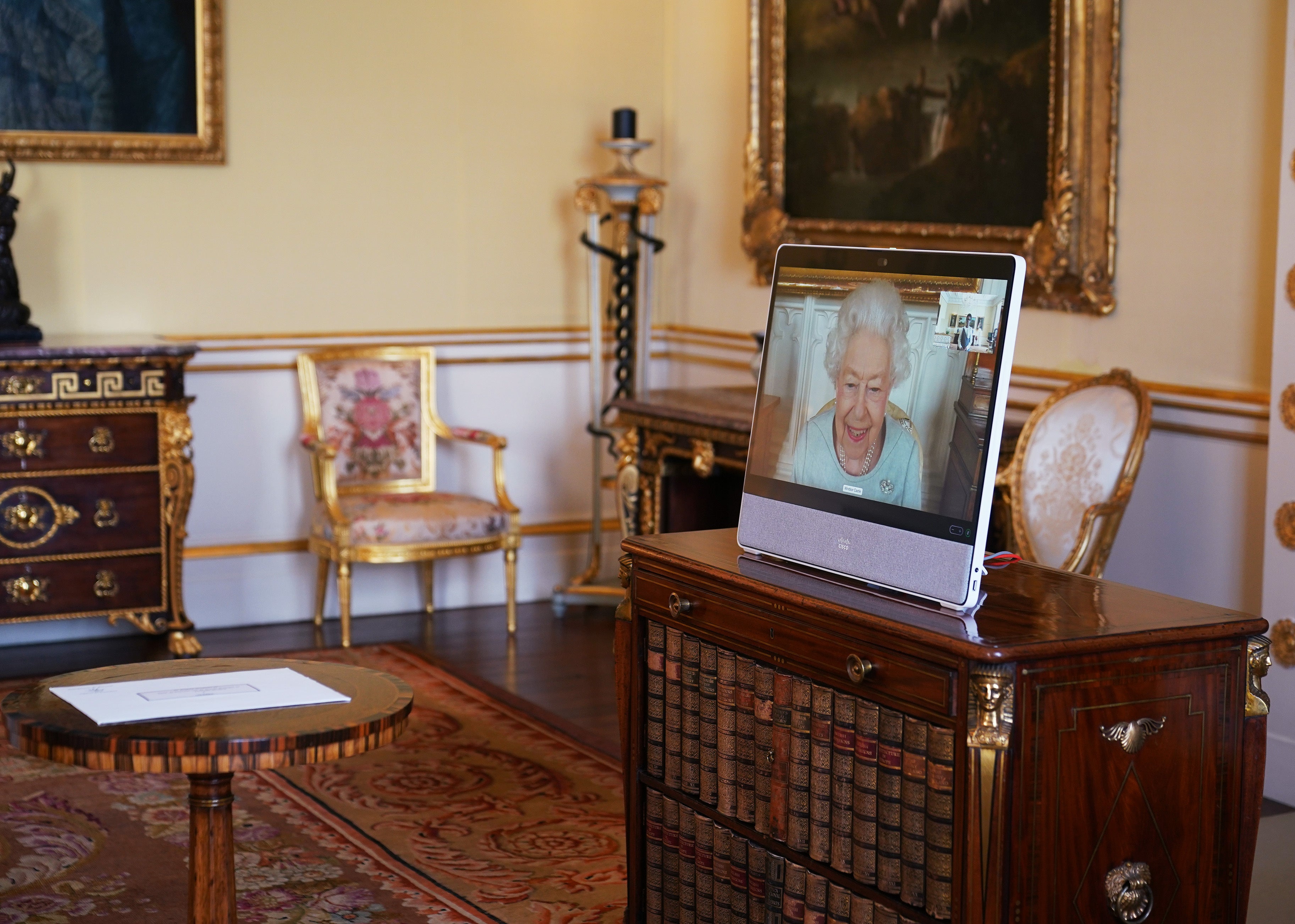 The Queen appears on a screen via videolink from Windsor Castle (Yui Mok/PA)