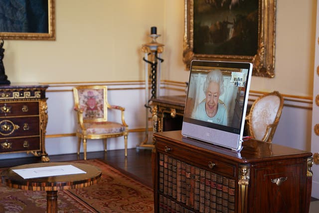 The Queen appears on a screen via videolink from Windsor Castle (Yui Mok/PA)