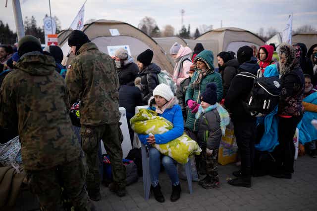Refugees fleeing war in neighbouring Ukraine arrive at a border crossing in Poland (Daniel Cole/AP)