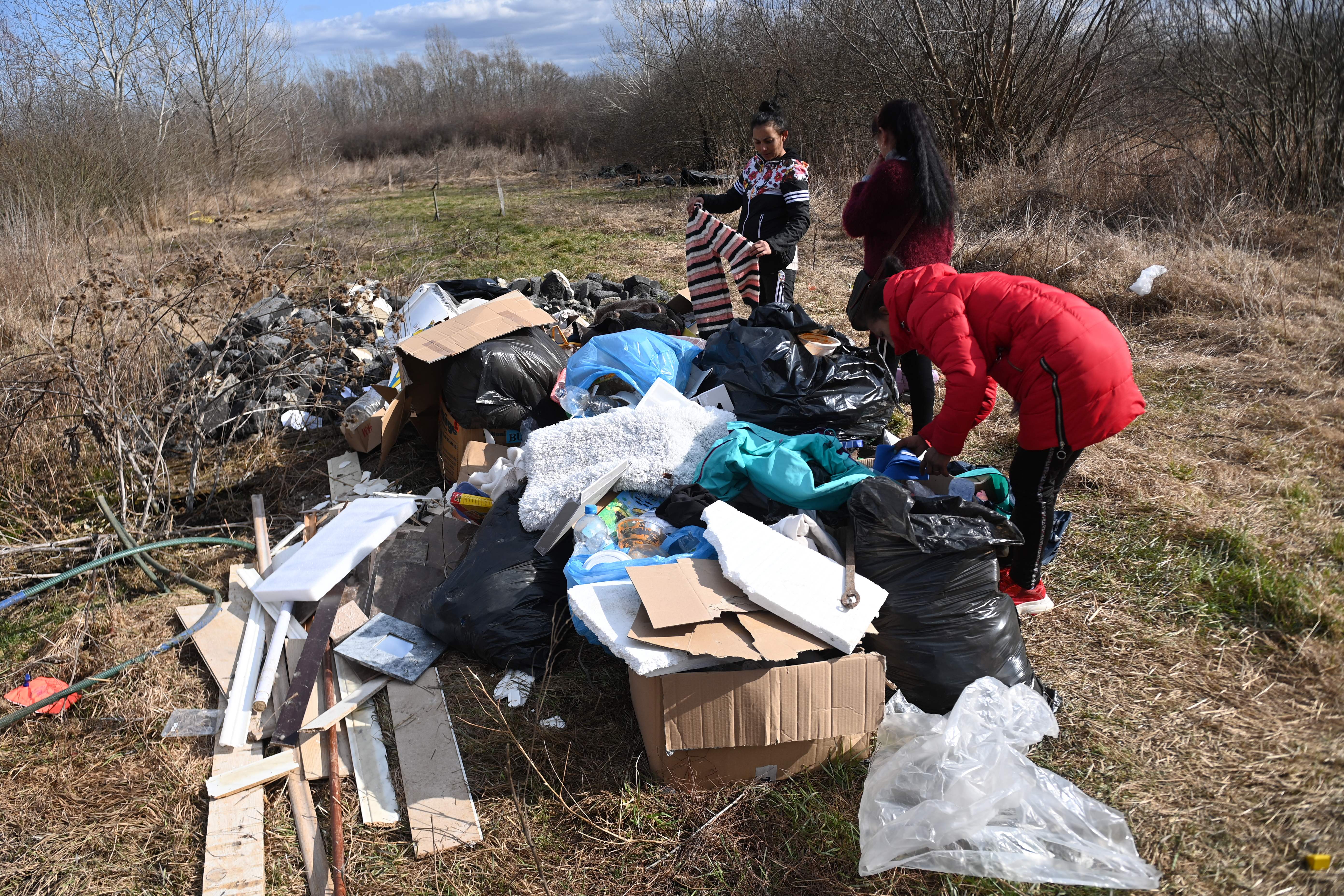 Romani refugees collect clothes for family members after crossing the border at Tiszabecs