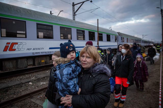 Family members accompany disabled Ukrainian children heading for Gdansk, near the border crossing in Medyka, Poland (Visar Kryeziu/AP)