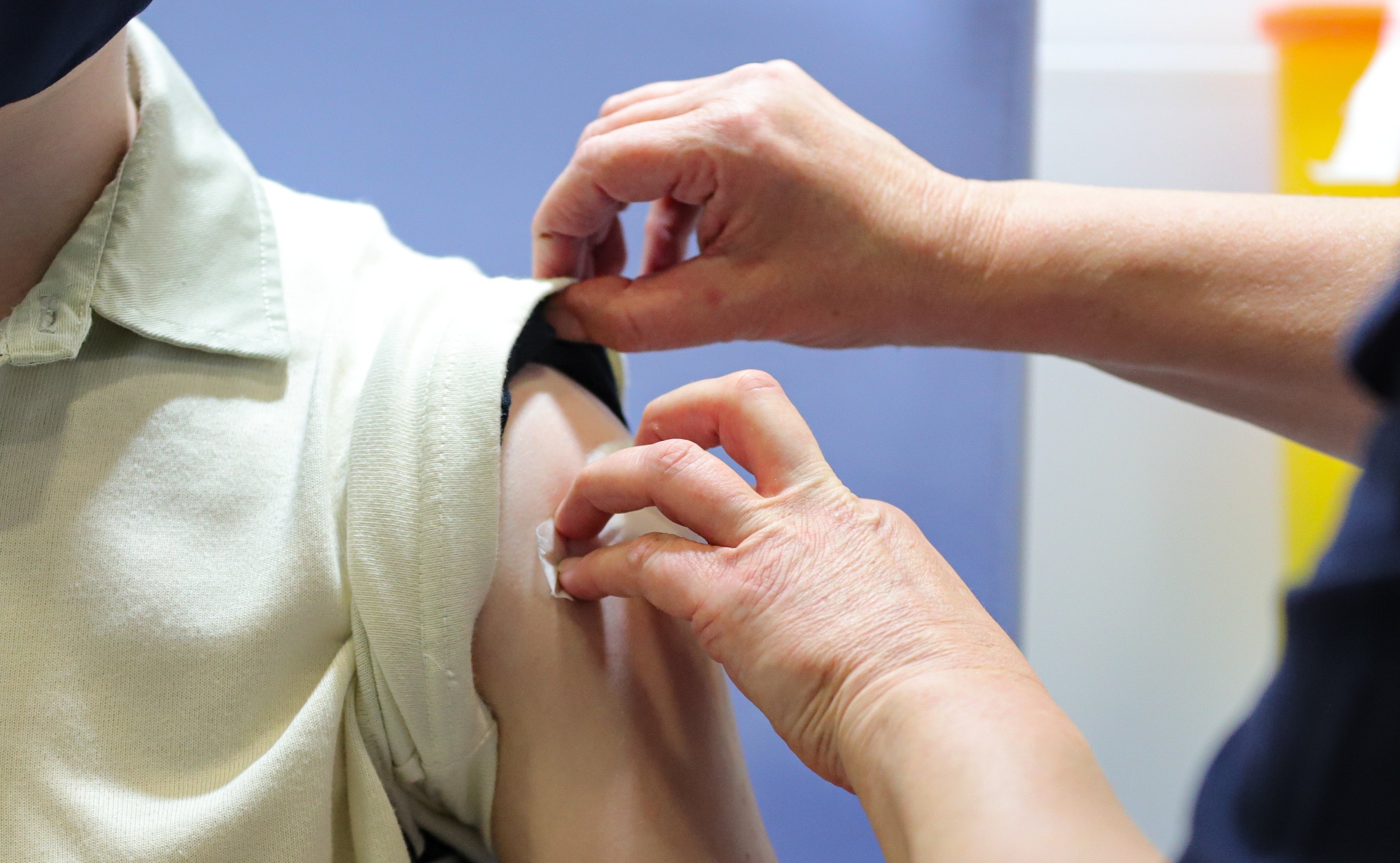 A child receiving a first dose of the Covid-19 vaccine (PA)