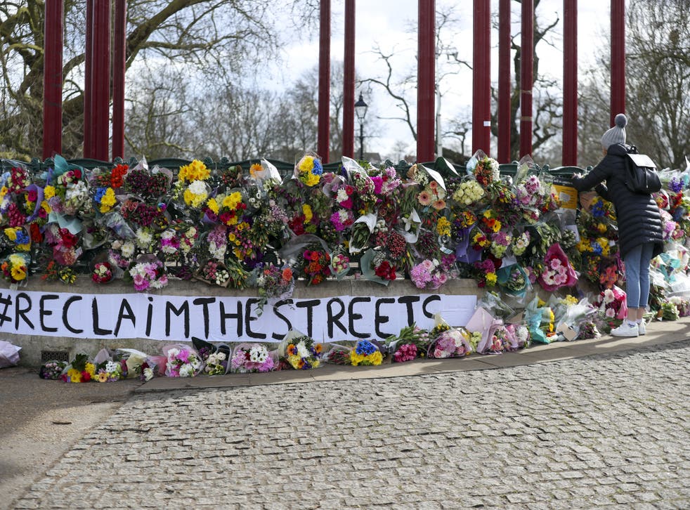 <p>People leave floral tributes at the band stand in Clapham Common, London, after the Reclaim These Streets vigil for Sarah Everard was officially cancelled (Steve Parsons/PA)</p>