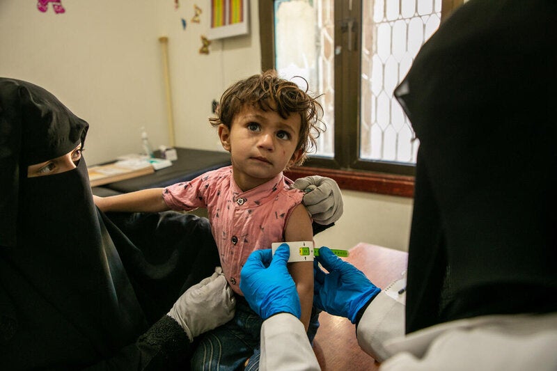 Ahed, aged three, is checked for malnutrition at a WFP-supported clinic in Yemen