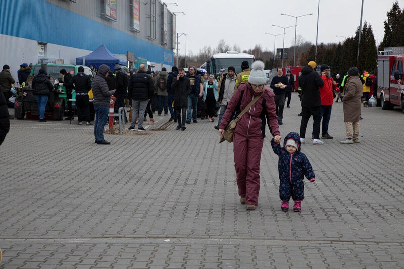 Ukrainian refugees arrive in their hundreds at a transit centre for housing and processing refugees in Hala Kijowska