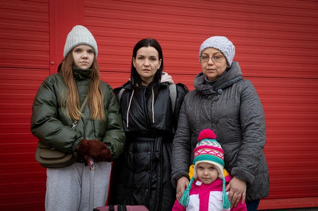<p>Daryna, centre, from Kyiv, with her daughters and mother-in-law, at the transit centre for housing and processing refugees in Hala Kijowska, Poland</p>
