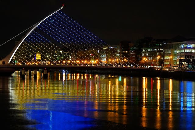 The Samuel Beckett Bridge in Dublin’s city centre displays the colours of the Ukrainian flag as a show of support. Blood bags and medical masks have been sent to Ukraine by Ireland (Brian Lawless/PA)