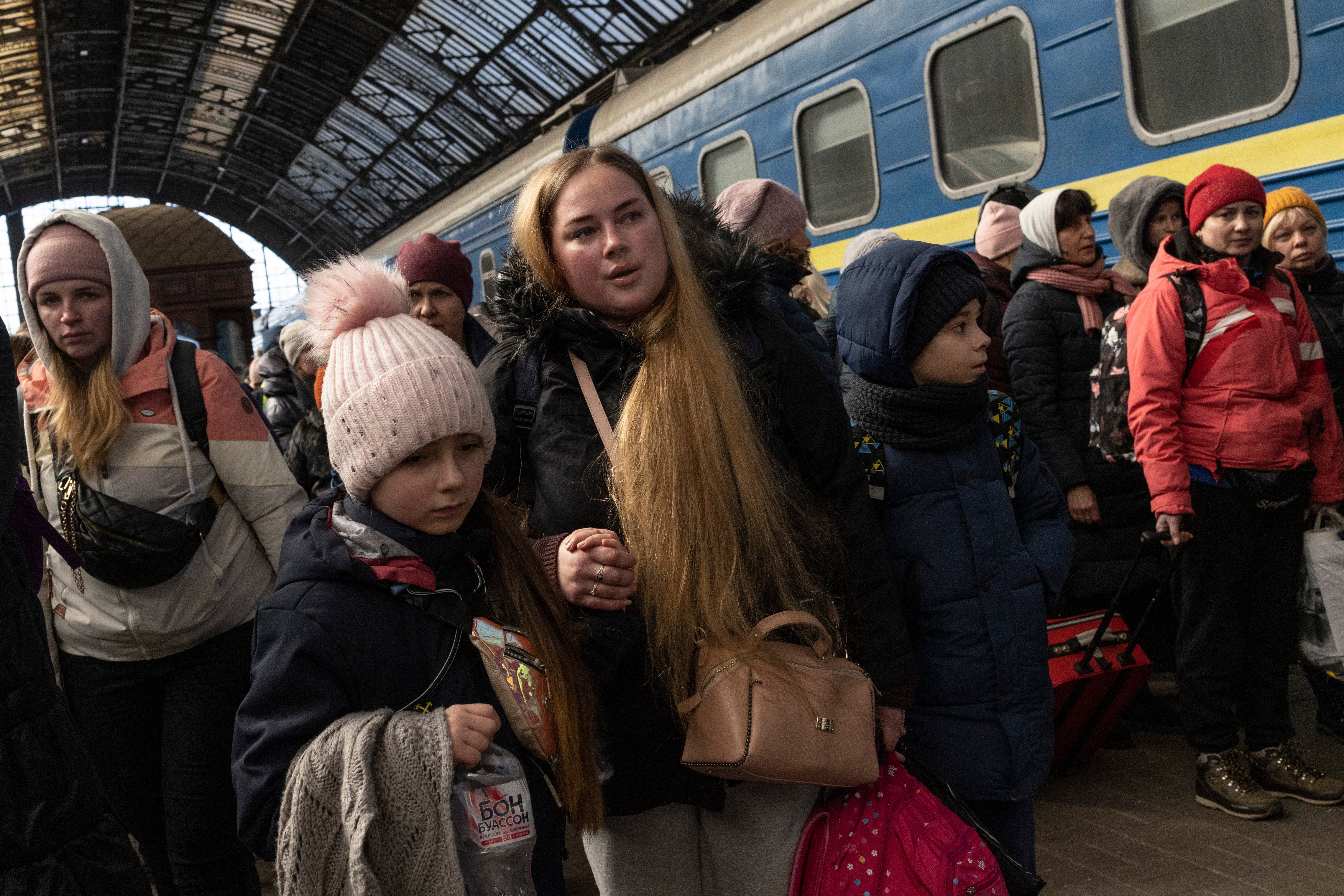 Passengers depart the railway station after disembarking trains from the east on March 11, 2022 in Lviv, Ukraine