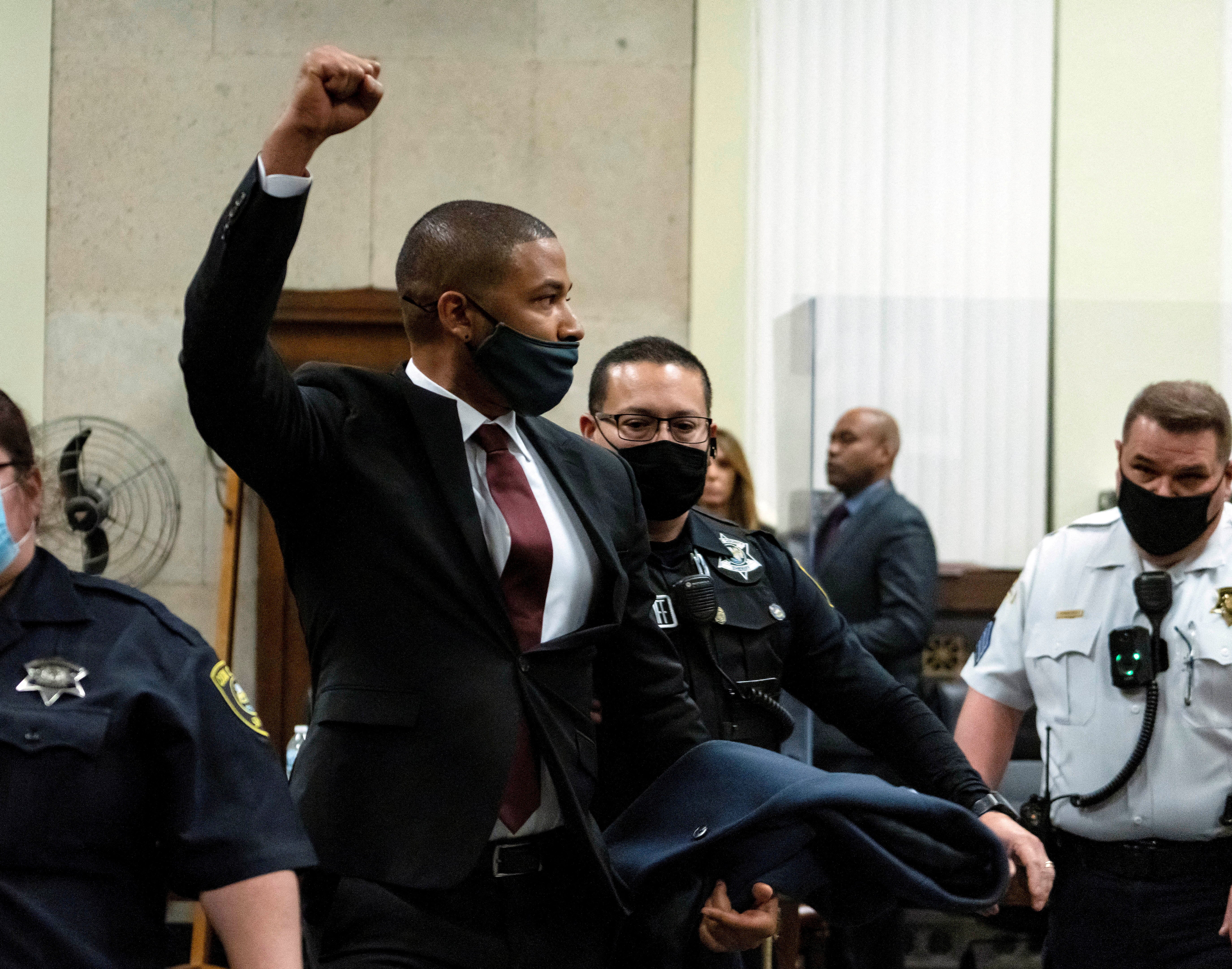 Smollett raises his fist as he’s led out of court following his sentencing